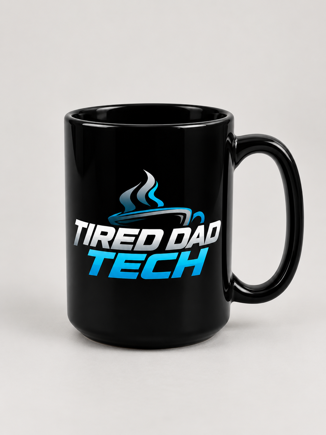 Black 15oz coffee mug with a cyan and white Tired Dad Tech design and handle on the right